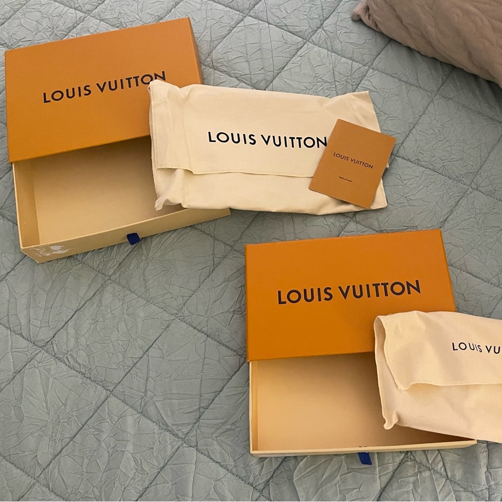 2 Louis Vuitton wallet boxes with dust cover and literature.